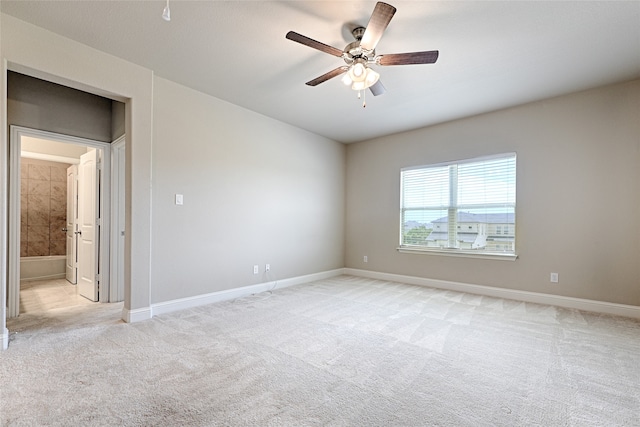 empty room with ceiling fan and light colored carpet