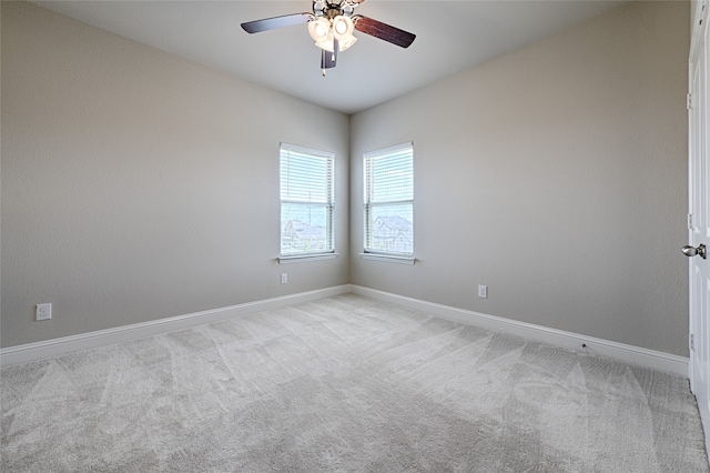 spare room featuring ceiling fan and light colored carpet