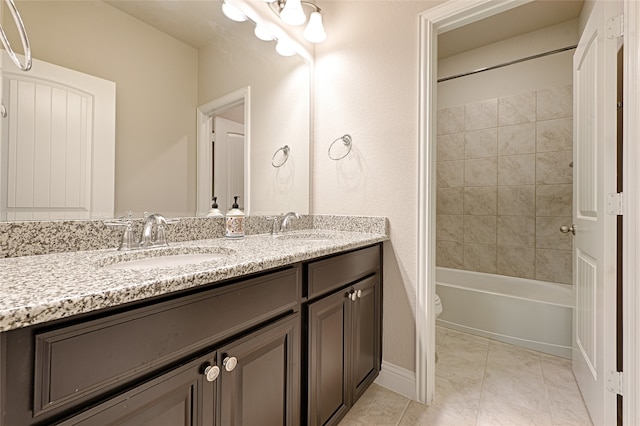 full bathroom with double vanity, toilet, tile patterned floors, and shower / tub combination