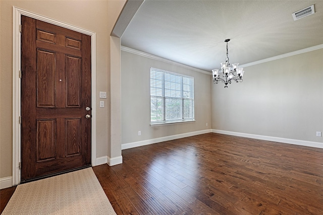 foyer featuring baseboards, visible vents, arched walkways, dark wood-style floors, and ornamental molding