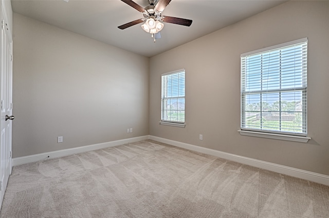 carpeted spare room with ceiling fan