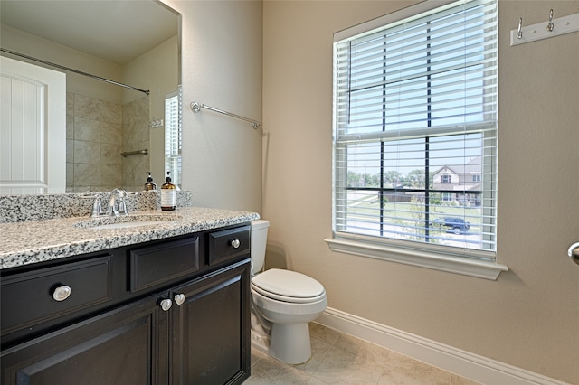 bathroom with vanity, tile patterned floors, and toilet