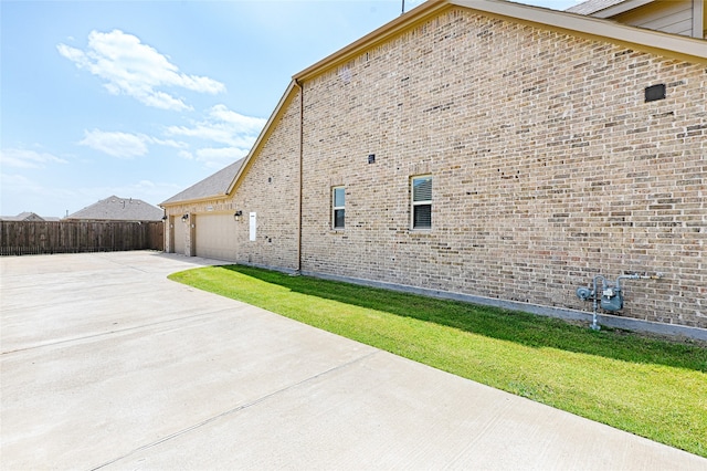 view of property exterior featuring a yard and a patio area