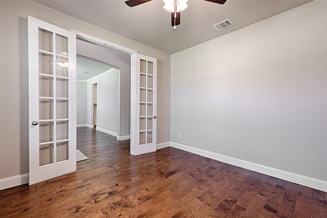 spare room with dark wood-type flooring, french doors, and ceiling fan