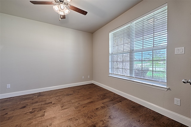 spare room featuring ceiling fan and dark hardwood / wood-style floors