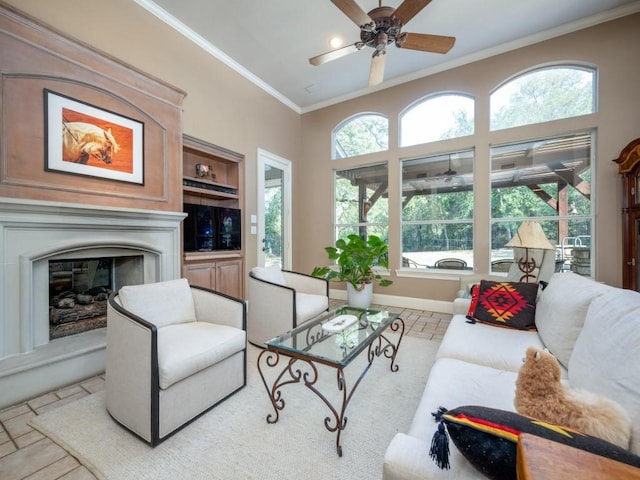 living room featuring ornamental molding and ceiling fan