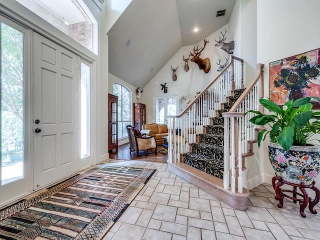 foyer featuring high vaulted ceiling and a wealth of natural light