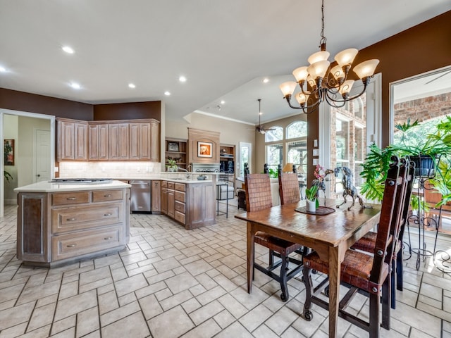 kitchen with hanging light fixtures, tasteful backsplash, a kitchen island, appliances with stainless steel finishes, and light brown cabinetry