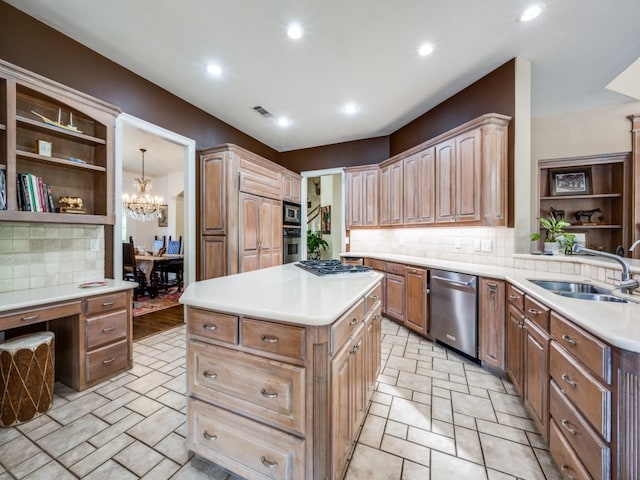 kitchen with appliances with stainless steel finishes, a center island, sink, and backsplash