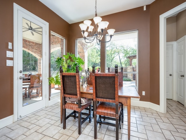 dining space featuring ceiling fan with notable chandelier and plenty of natural light