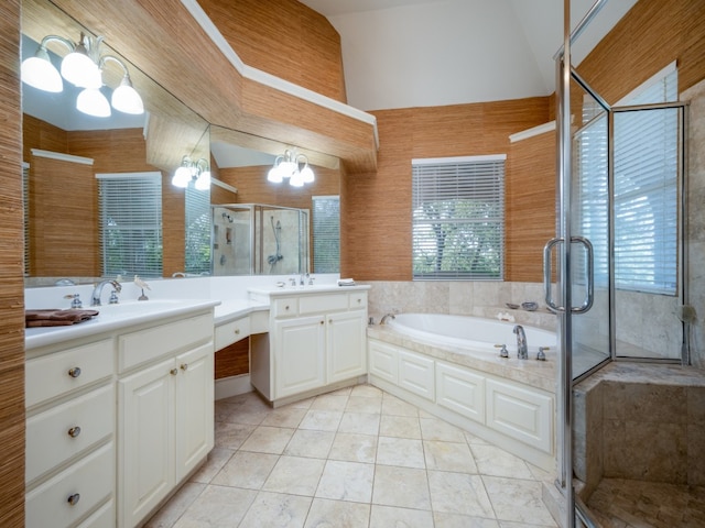 bathroom with wooden walls, vanity, vaulted ceiling, tile patterned floors, and separate shower and tub