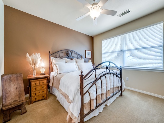 bedroom with ceiling fan and light colored carpet