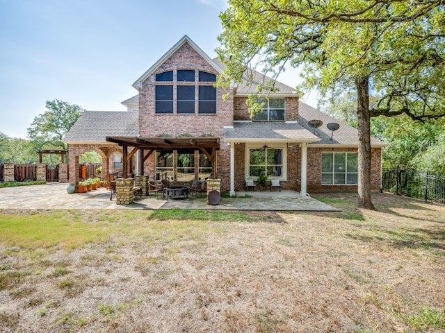 back of property with a patio, a lawn, and a pergola