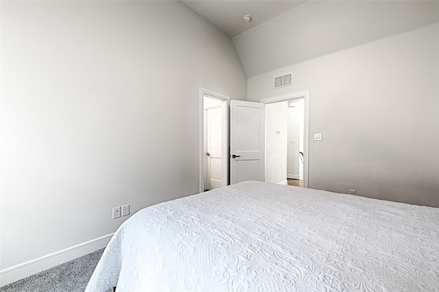 carpeted bedroom featuring lofted ceiling