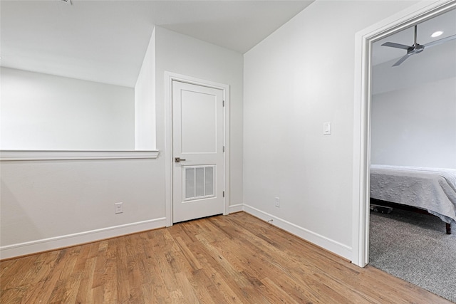 unfurnished bedroom featuring light wood-style flooring, visible vents, and baseboards