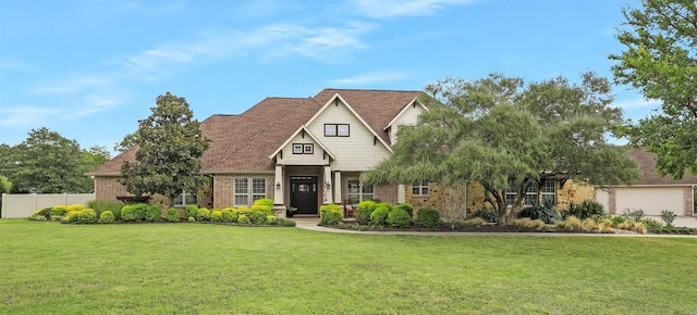 craftsman house featuring brick siding, fence, and a front yard