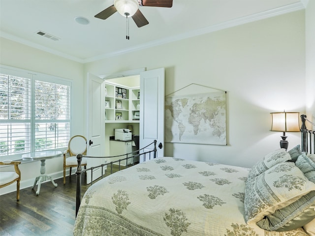 bedroom featuring ornamental molding, dark wood finished floors, visible vents, and baseboards