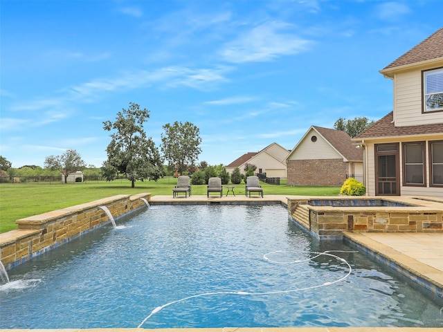 view of swimming pool featuring a pool with connected hot tub, a patio, and a yard