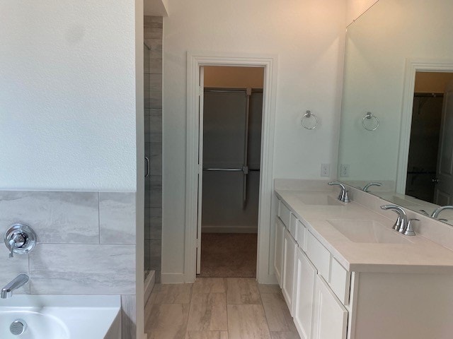 bathroom with vanity and a bath