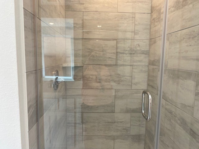 interior details with an enclosed shower