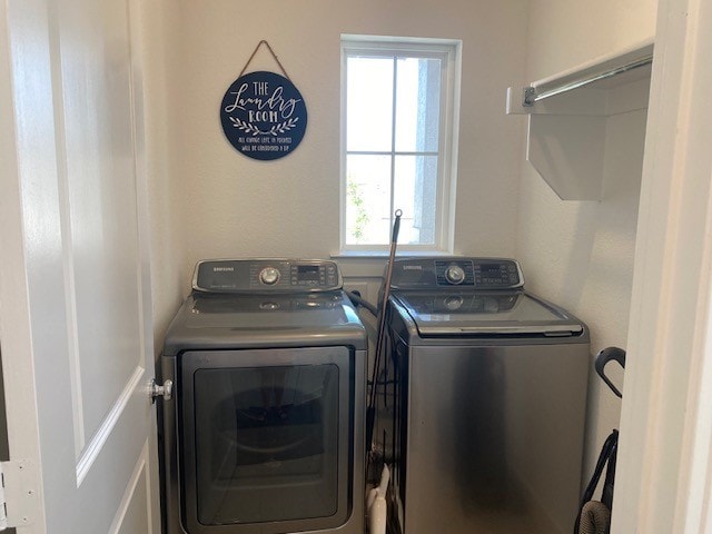 laundry room with separate washer and dryer and a healthy amount of sunlight