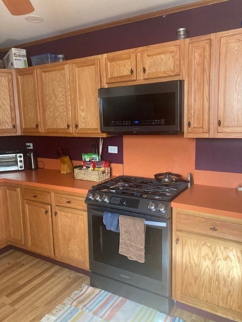 kitchen with stainless steel appliances and light wood-type flooring