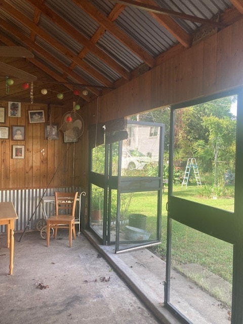 unfurnished sunroom with lofted ceiling