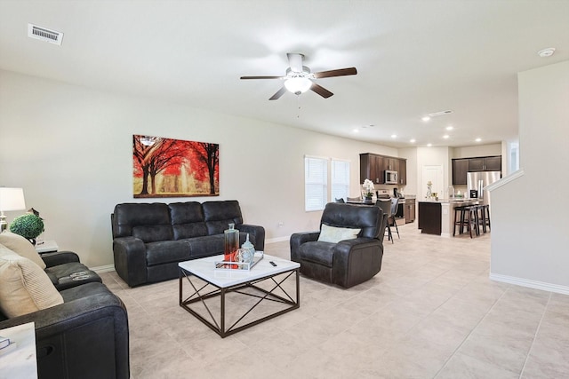 living room with ceiling fan and light tile patterned floors