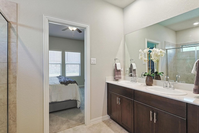 bathroom with tile patterned flooring, vanity, and walk in shower