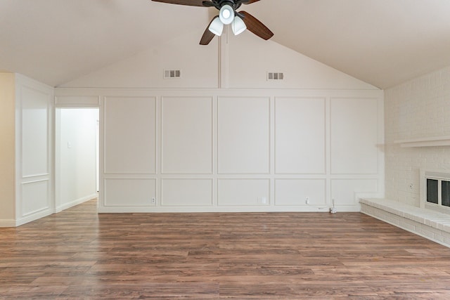 unfurnished living room with a fireplace, wood-type flooring, high vaulted ceiling, and ceiling fan