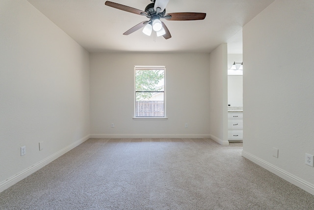 spare room with light carpet and ceiling fan