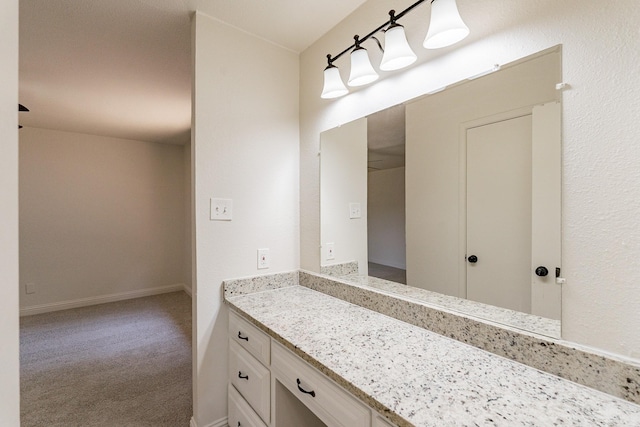 bathroom featuring vanity and baseboards