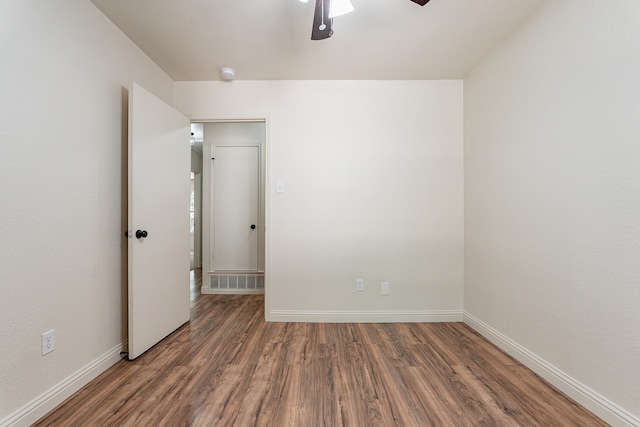 spare room featuring wood-type flooring and ceiling fan