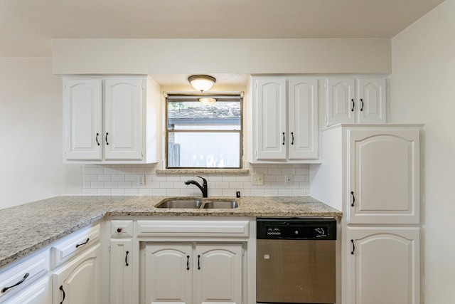 kitchen featuring stainless steel dishwasher, white cabinetry, tasteful backsplash, sink, and light stone counters