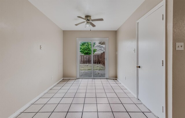 empty room featuring ceiling fan and light tile patterned floors