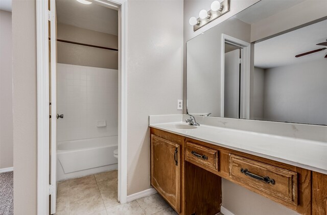 full bathroom with vanity, shower / tub combination, toilet, tile patterned floors, and ceiling fan