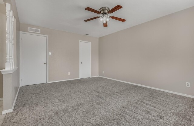 unfurnished room featuring ceiling fan and carpet floors