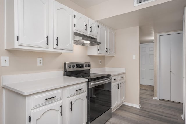 4500 Larner St, The Colony, TX 75056 - kitchen featuring electric range, under cabinet range hood, white cabinets, and light wood-style floors