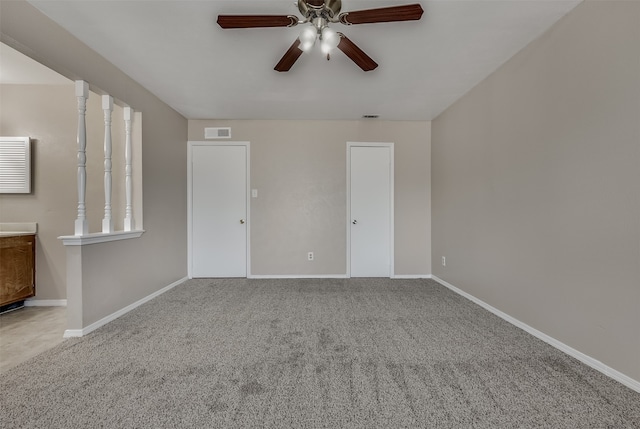 empty room with ceiling fan and light carpet