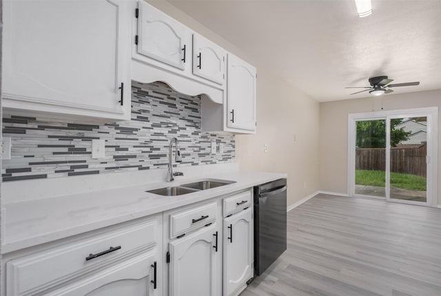 4500 Larner St, The Colony, TX 75056 - kitchen featuring dishwashing machine, a sink, ceiling fan, decorative backsplash, and white cabinets