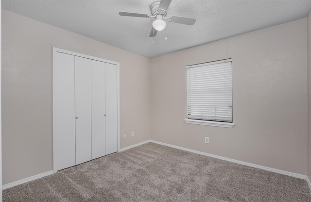 4500 Larner St, The Colony, TX 75056 - unfurnished bedroom featuring carpet, a closet, baseboards, a textured ceiling, and ceiling fan