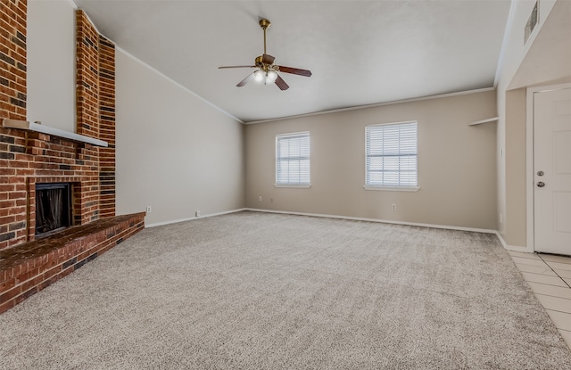 unfurnished living room with ornamental molding, light colored carpet, a brick fireplace, and ceiling fan