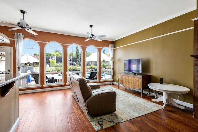 living room featuring hardwood / wood-style flooring, ceiling fan, and ornamental molding