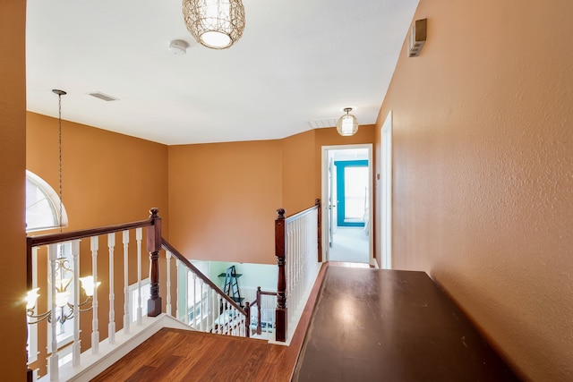 stairway featuring wood-type flooring and plenty of natural light