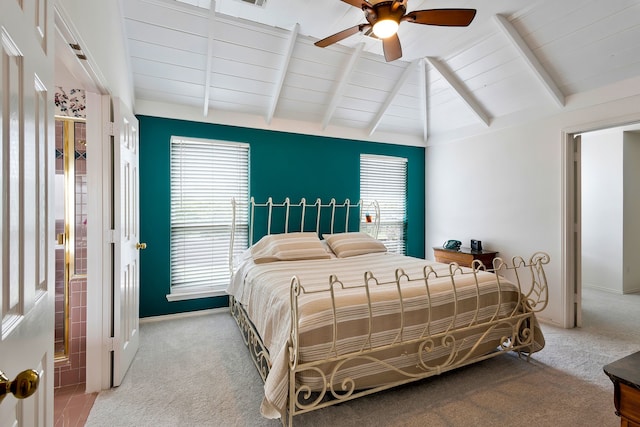 carpeted bedroom featuring lofted ceiling with beams and ceiling fan