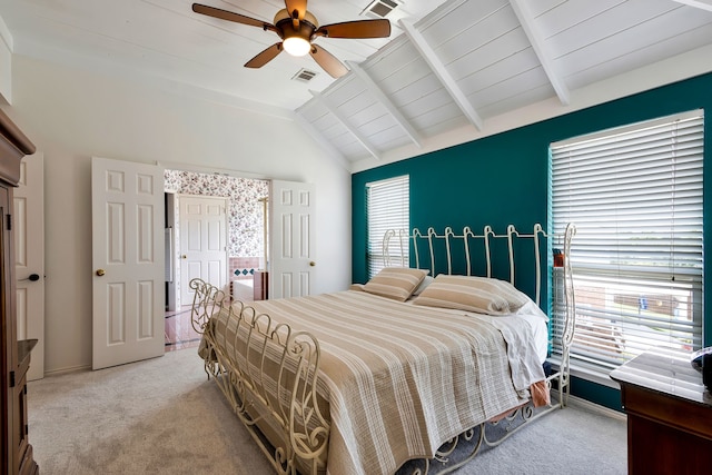 bedroom with multiple windows, light colored carpet, ceiling fan, and lofted ceiling with beams