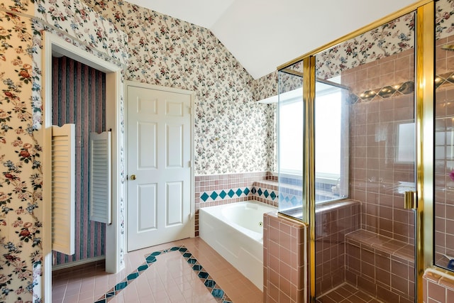 bathroom featuring tile patterned flooring, lofted ceiling, and plus walk in shower