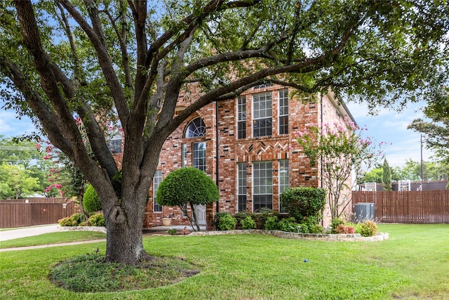 view of front of property featuring central AC and a front yard