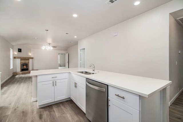 kitchen with white cabinets, dishwasher, hardwood / wood-style floors, and sink