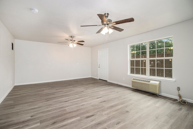 empty room with ceiling fan and hardwood / wood-style floors